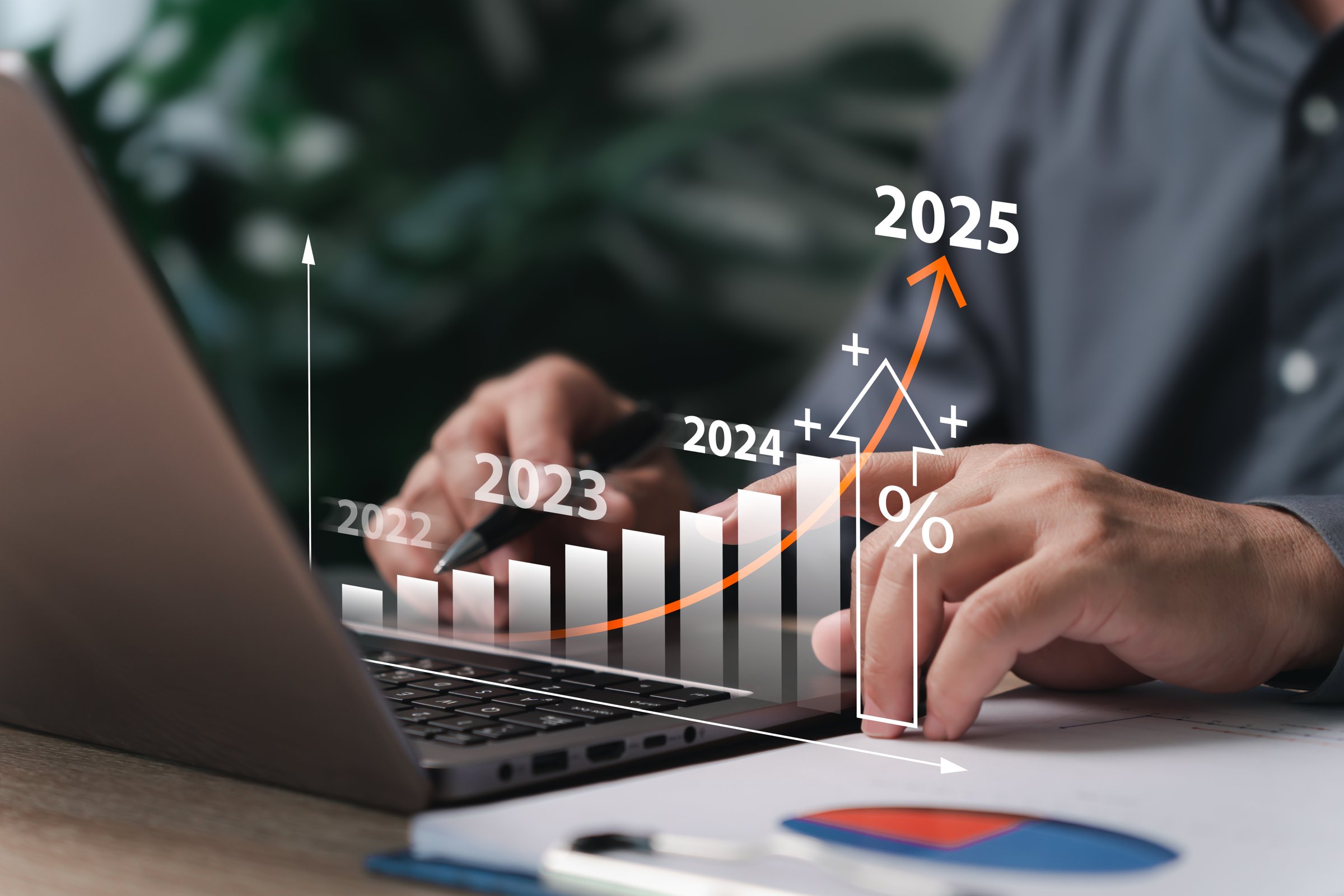 Business goal setting and target concept, Businessman use laptop plan financial analysis chart strategically for the new year calculating financial data for long-term investments.